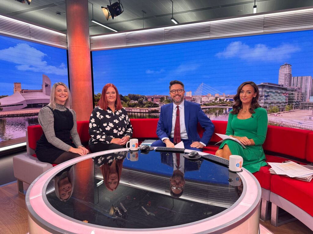A group photo, left to right of Aileen Edmunds, Longleigh Foundation CEO; Claire Donovan, End Furniture Poverty Director; Jon Kay and Sally Nugent, BBC Breakfast Presenters sat around a table in the BBC studio
