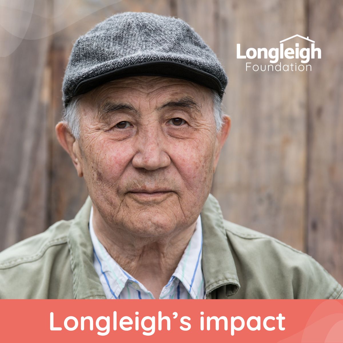 An older man wearing a gray flat cap and light green jacket looks calmly at the camera, standing in front of a wooden background. The image includes the Longleigh Foundation logo in the top right corner and the text “Longleigh’s impact” along the bottom on an orange banner.